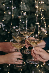 glasses with champagne on the background of light bulbs