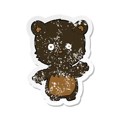 retro distressed sticker of a cartoon black bearcub waving