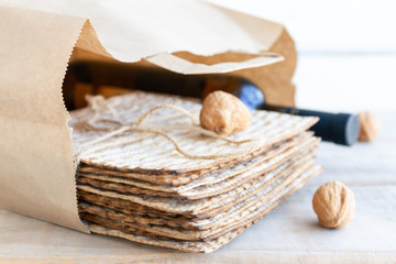 Passover grocery shopping composition with a matzah or matza and red kosher in a shopping bag.