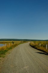 Gravel road travels through the Harvey Bank area of the Eastern Atlantic coast of Canada