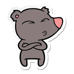 sticker of a cartoon whistling bear