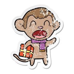 distressed sticker of a shouting cartoon monkey carrying christmas gift