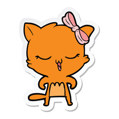 sticker of a cartoon cat with bow on head