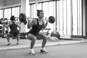 Fitness young girl in the gym doing exercises