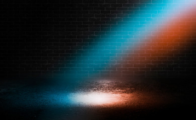 Dark empty stage, blue and orange neon spotlight, wet asphalt, smoke, night shooting, rays