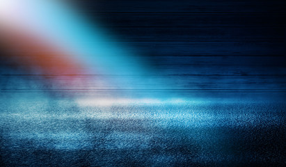 Obraz premium Dark empty stage, blue and orange neon spotlight, wet asphalt, smoke, night shooting, rays
