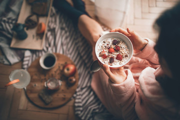 Young Girl having breakfast on the floor. Lifestyle concept.