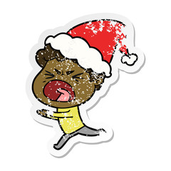 distressed sticker cartoon of a furious man wearing santa hat