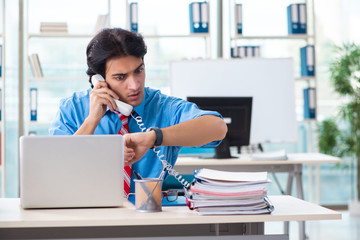 Handsome businessman unhappy with excessive work in the office 