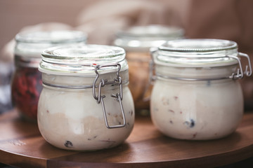Natural yogurt, organic greek bio yoghurt homemade with fresh fruits, goji and berries, ready for diet breakfast, sweet tasty dessert in a jar for the morning
