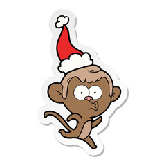 sticker cartoon of a surprised monkey wearing santa hat