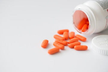Prescription medicine cascading out of white pharmacy bottle