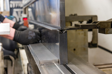 operator bending metal sheet by sheet bending machine