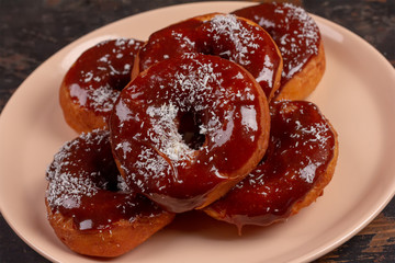 donuts in caramel in pink plate close up