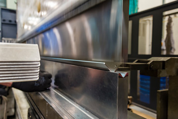 operator bending metal sheet by sheet bending machine