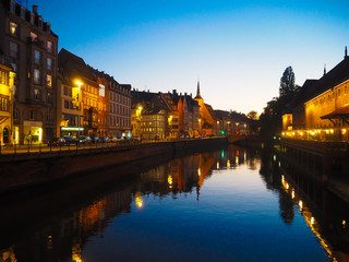 Fototapeta na wymiar River view in Strassbourg in the evening - Beautyful city line at night with reflection in the rhine in Strasbourg