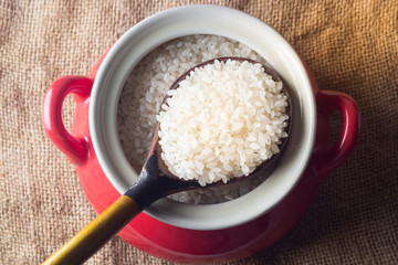 Wooden spoon with rice is a pot of rice
