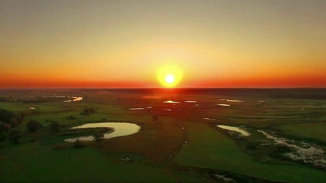 aerial view of river at sunrise 4K, fly over morning mist on the river, Very high view of the river at sunrise, Aerial view of mystical river at sunrise with fog, sun above the river aerial