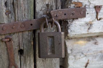 Old rusty lock on old wooden door. Vintage.