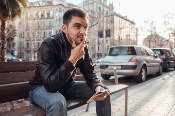 Fototapeta premium Brunette man with beard writing and thinking in notebook