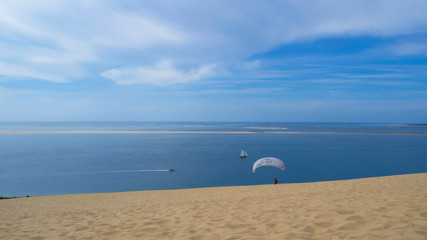 Beautiful Beach - Paraglider at lonely beach with wide horizon line - Paragliding - Surfing  Dune du Pilat 