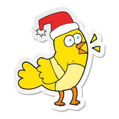 sticker of a cartoon bird wearing christmas hat