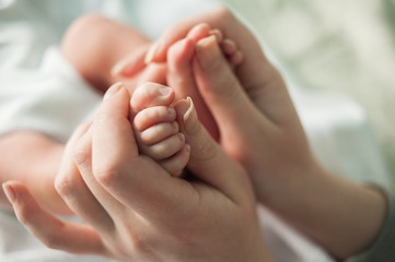 baby feet in mother's hands