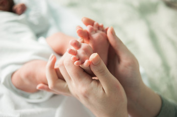 baby feet in mother's hands