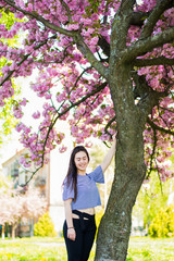 Plus size fashion model in casual clothes, overweight female body in a park outdoors. Spring concept.