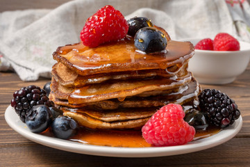 Pancakes with berries and honey. Soft focus
