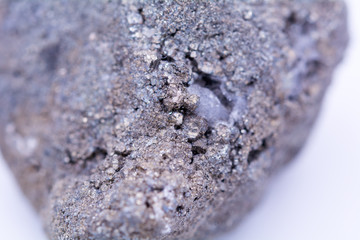 A natural stone with blue shades, dust, rust and dirt on the surface, macro, close up