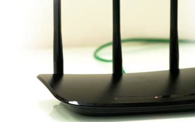 Switched-on wifi router closeup on light background.
