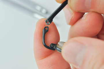 Repairing the broken eyeglasses.