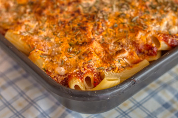 Detail of baking tray with appetizing Italian pasta au gratin