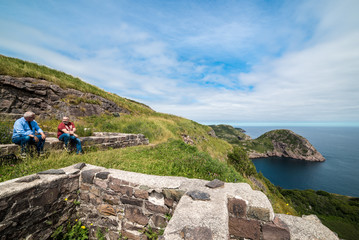 men resting on old stone foundation