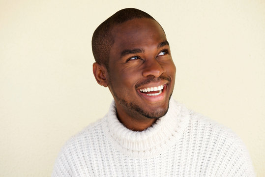 Close up handsome african american man thinking and looking away while smiling