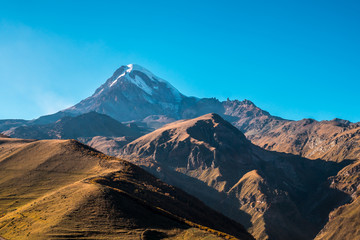 Mount Kazbek (Mkinvartsveri) at sunny day. Caucasus mountains