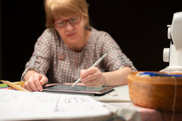 female designer draw clothes sketch on paper