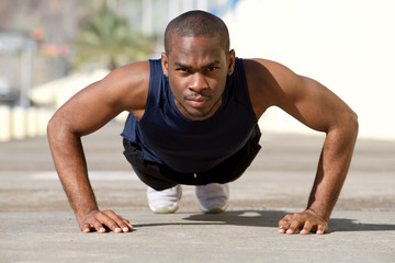 Fototapeta na wymiar healthy young black man doing pushups outside