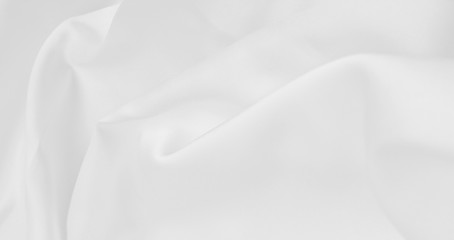 Obraz premium Smooth elegant white silk or satin luxury cloth texture as wedding background. Luxurious background design