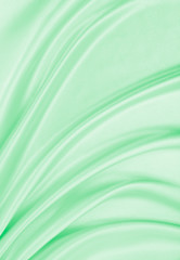 Smooth elegant green silk or satin luxury cloth texture as abstract background. Luxurious background design