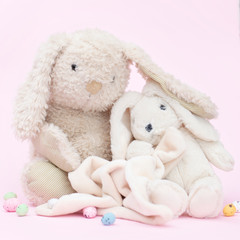 Toy rabbits on a pink background