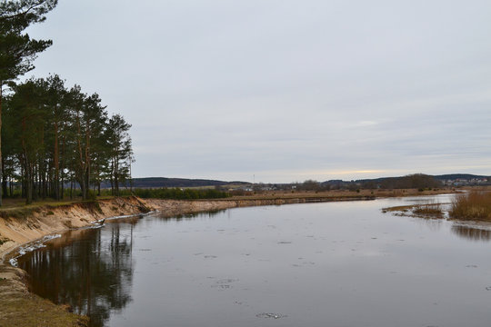 Spring nature scene. Forest and river landscape in winter day