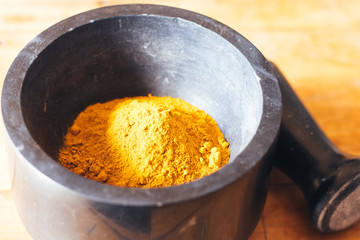 Turmeric powder in a mortar and pestle.