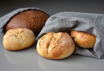 Reusable zero waste linen bread bags, close up view on gray background.