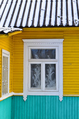 Old window frame in traditional wooden village close up. Front view.
