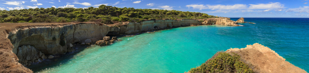 The most beautiful coast of Apulia: Torre Sant' Andrea, Otranto , ITALY (Lecce).Typical coastline of Salento: view of Punticeddha beach. Seascape with cliffs, rocky arch and sea stacks (faraglioni).