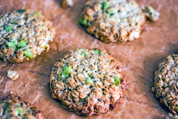 Homemade oatmeal cookies with candied fruit on parchment paper, close-up. Gluten-free and sugar-free baking of oatmeal baking with your own hands