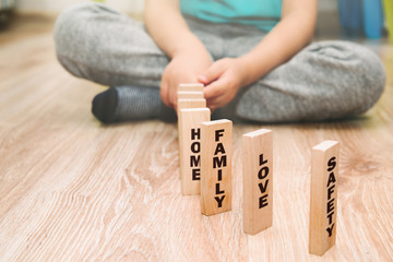 The most important family values presented by the child. The little boy arranges wooden blocks with...