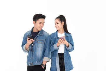 young Asian couple using smartphone on white background